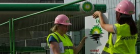 Demonstrators hang signs on a fence they have used to barricade a BP station in London, July 27, 2010. (AFP/Getty Images)