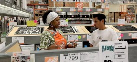 Home Depot saleswoman Susan McKenzie, left, explains the appliance rebate program to customer Angel Robles of Chicago. (Antonio Perez/Chicago Tribune)