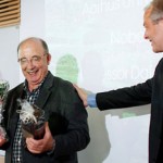 American economist Dale Mortensen, 71, center, is welcomed to a press conference at the University of Aarhus, in Aarhus, Denmark, Monday Oct. 11, 2010. (Polfoto/Andreas Szlavik)