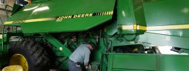 A John Deere combine being worked on in Hampshire, Ill. Moline-based Deere is expanding into Russia. (Photo by Scott Olson/Getty Images)
