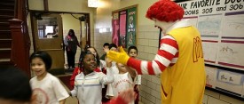 Ronald McDonald slaps first graders hands as they head to lunch at Charles Gates Dawes Elementary School  in 2008. (Heather Stone/Chicago Tribune)