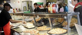 A Sbarro Inc. employee serves patrons at a restaurant in Columbus, Ohio. (Reuters_